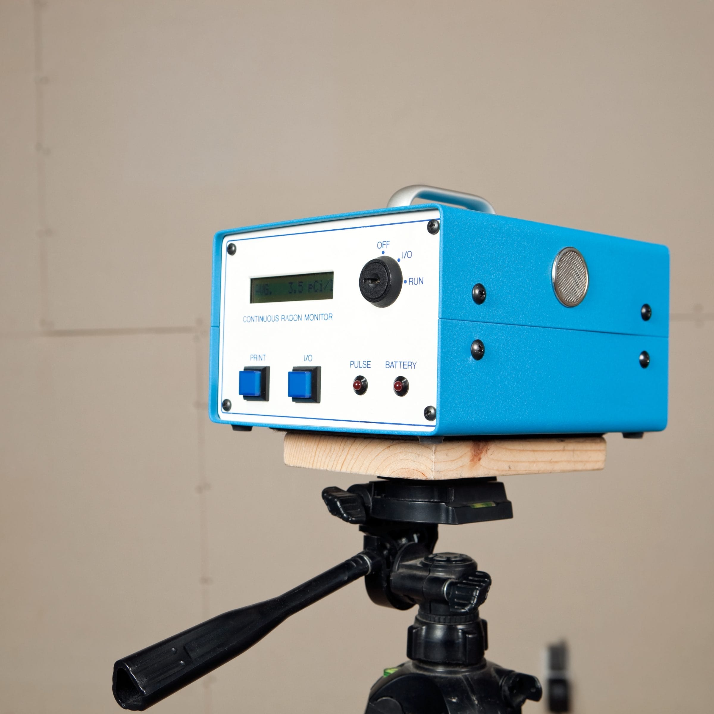 A blue, square radon testing device.